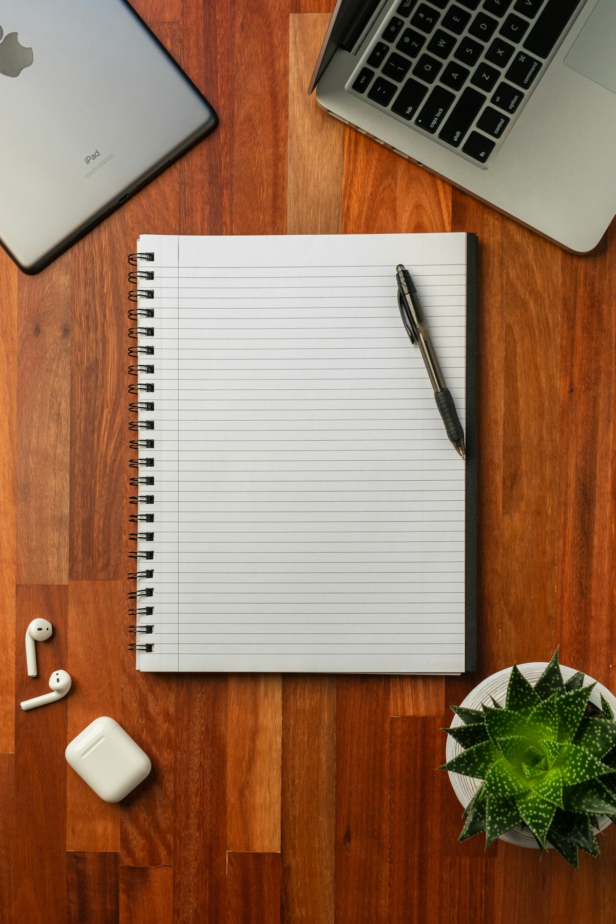 A tidy desk workspace with a notebook and pen