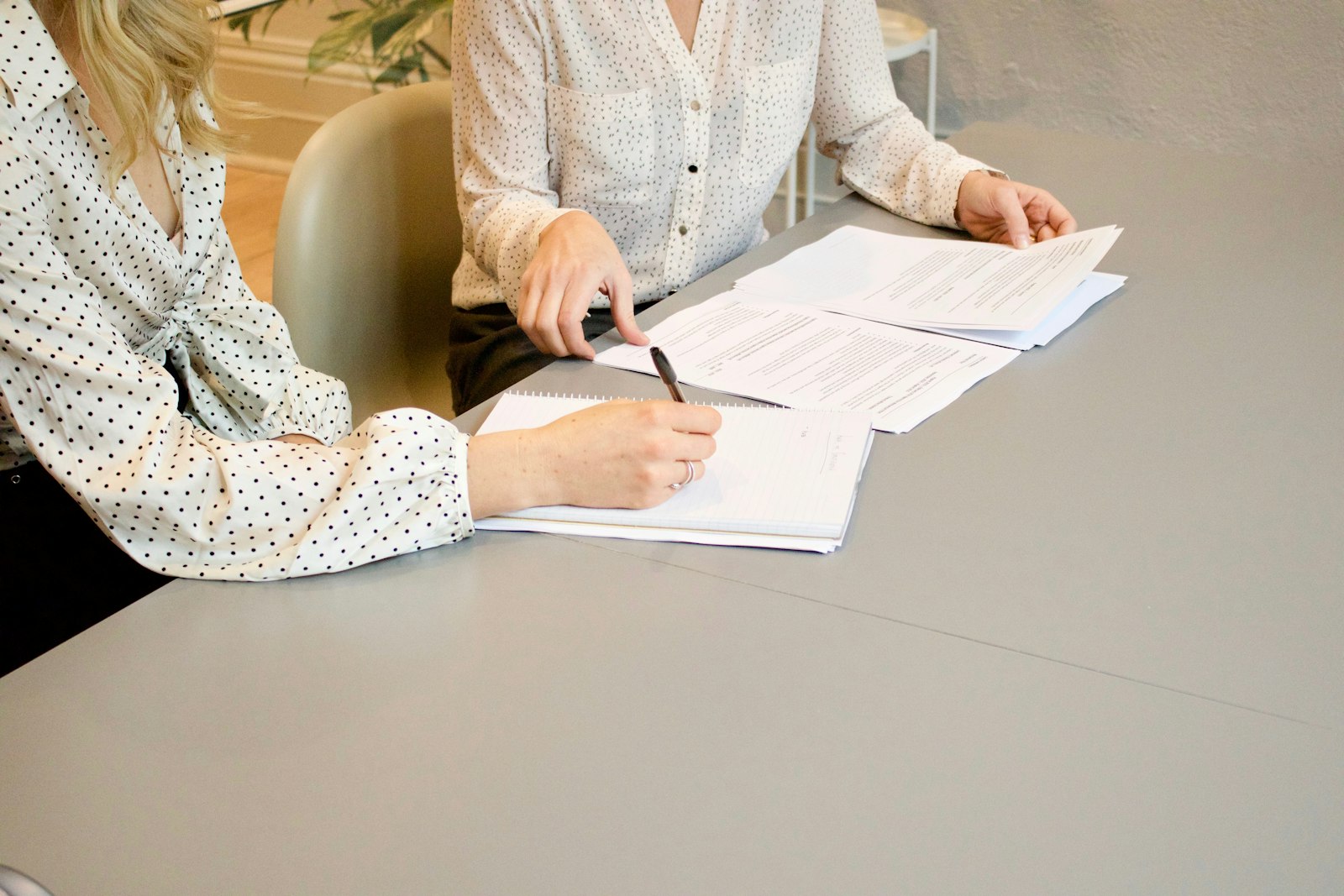 Signing and reviewing documents at a table